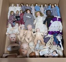 Assortment of small bisque dolls and loose body parts