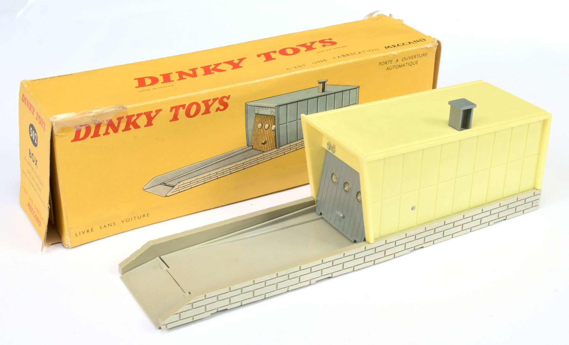 French Dinky Toys 502 Garage - Plastic issue grey base and opening door, with bright yellow garage