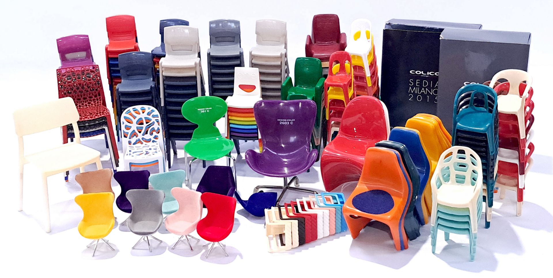 Collection of dolls house furniture chairs, mostly plastic, in a range of colours, sizes and styl...