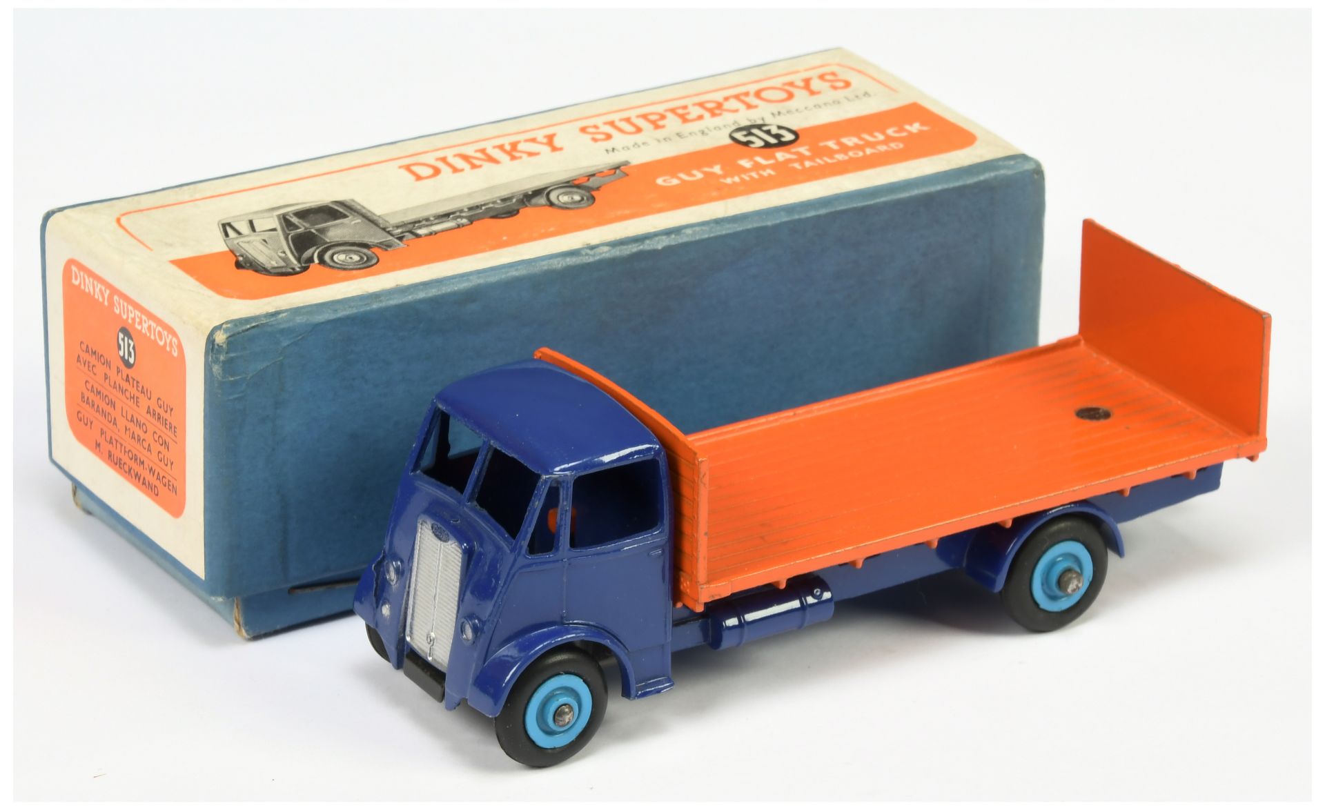 Dinky toys 513 Guy (type 2) Flat Truck with Tailboard - Blue cab and chassis, orange back, mid-bl...