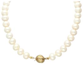Cultivated pearl necklace with 14K yellow gold ball clasp.