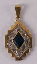 An 18 kt gold Art Deco pendant with a diamond-cut blue sapphire.