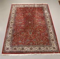 An Oriental wool carpet with a round background and floral motifs,