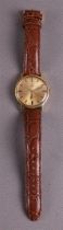 A vintage Omega Genève Sunburst men's wristwatch on a brown leather strap, 1969.