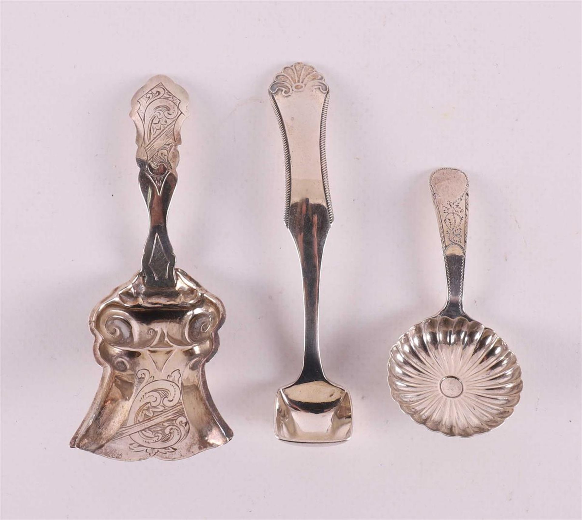 A silver tea spoon, mustard spoon and sugar spoon, 19th century.