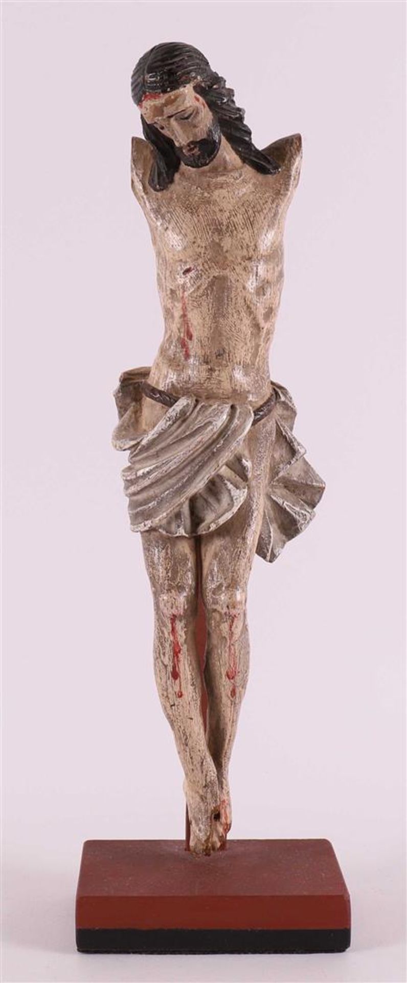 A carved polychrome wooden corpus Christi in metal stand, 19th century