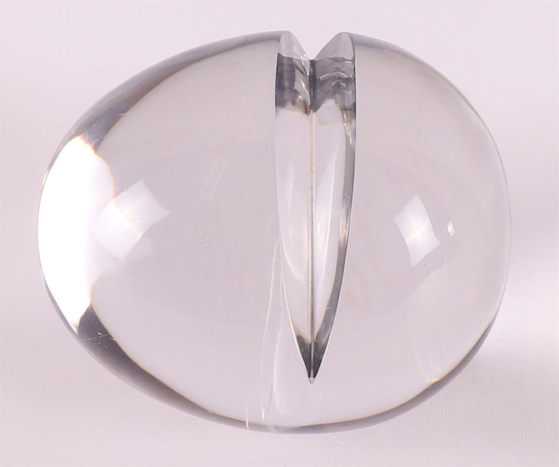A clear glass design egg with incision, signed on the bottom 'T.H. Riha'