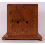 An Art Deco mantel clock in walnut casing, ca. 1930.