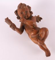 A carved pearwood amor with a torch in his hand, 18th century.