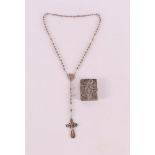 A filigree silver rosary with matching holder, 1st half 20th century.