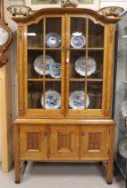 A two-door display cabinet, early 20th century.