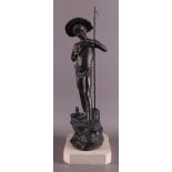 A bronzed white metal boy with hat and fishing rod with fish, around 1900.