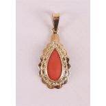 A yellow gold drop-shaped pendant, set with cabochon cut red coral