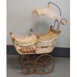 A rattan doll's pram with parasol, 19th century.