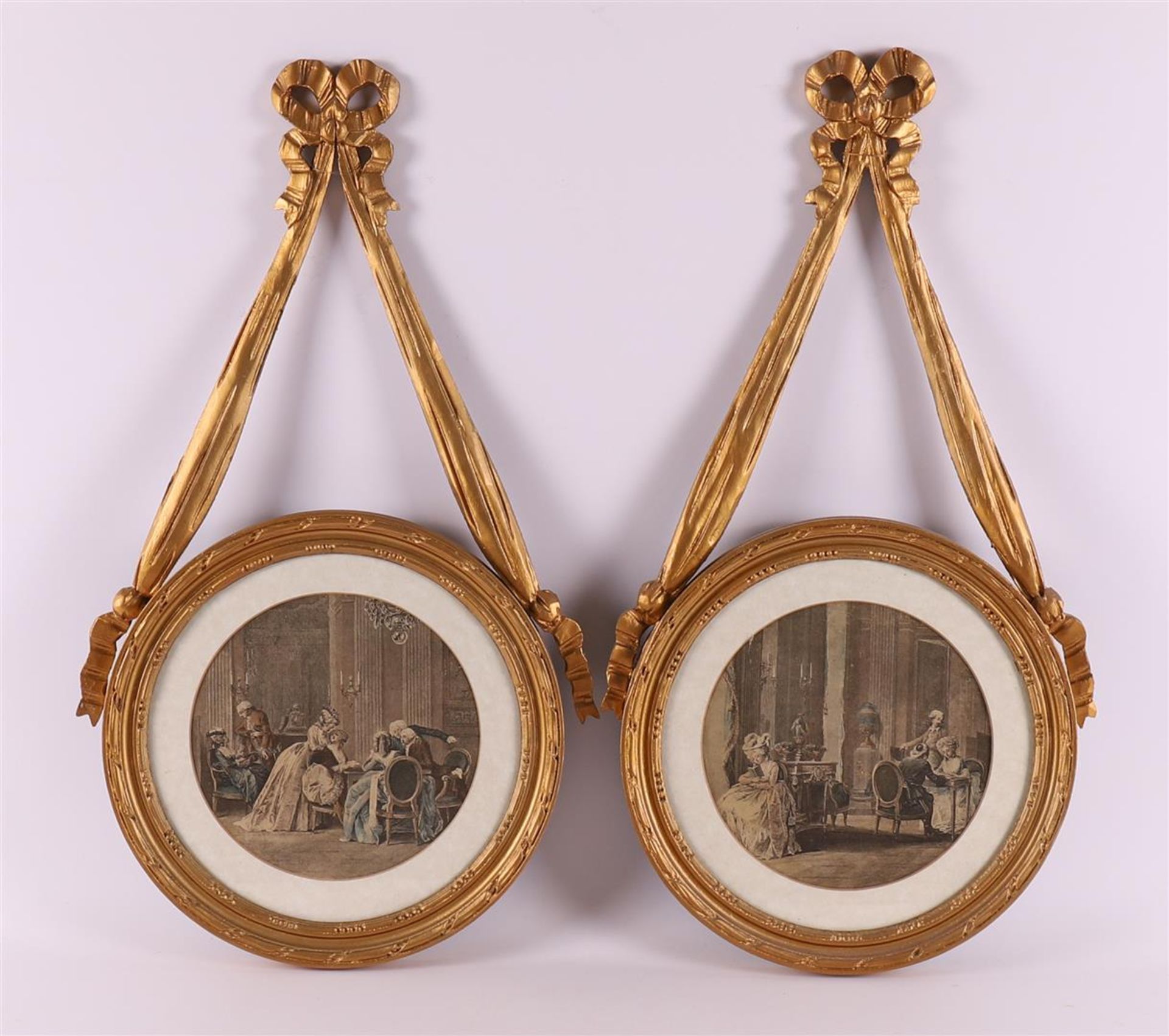 A set of round gilt wooden frames with bow ornament, 19th century.
