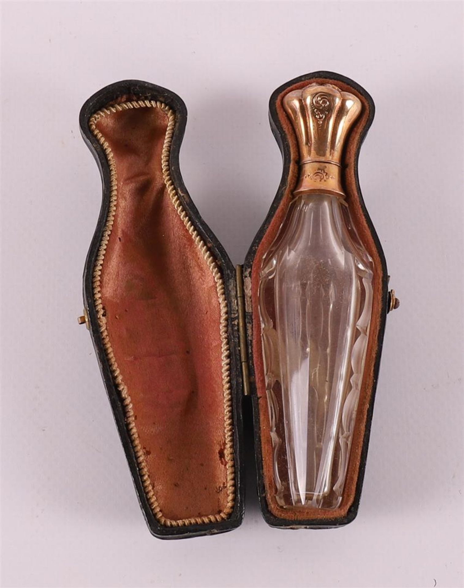 A clear crystal odor flask with gold lid, 19th century.