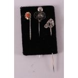 Three various tie pins, including gold set with cabochon cut red coral.