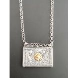 Silver tinder box with 14 kt gold application, on ditto silver necklace.