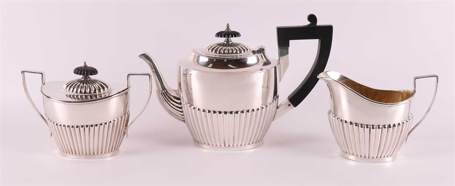 A silver teapot with sugar lid and milk jug, England, Sheffield,
