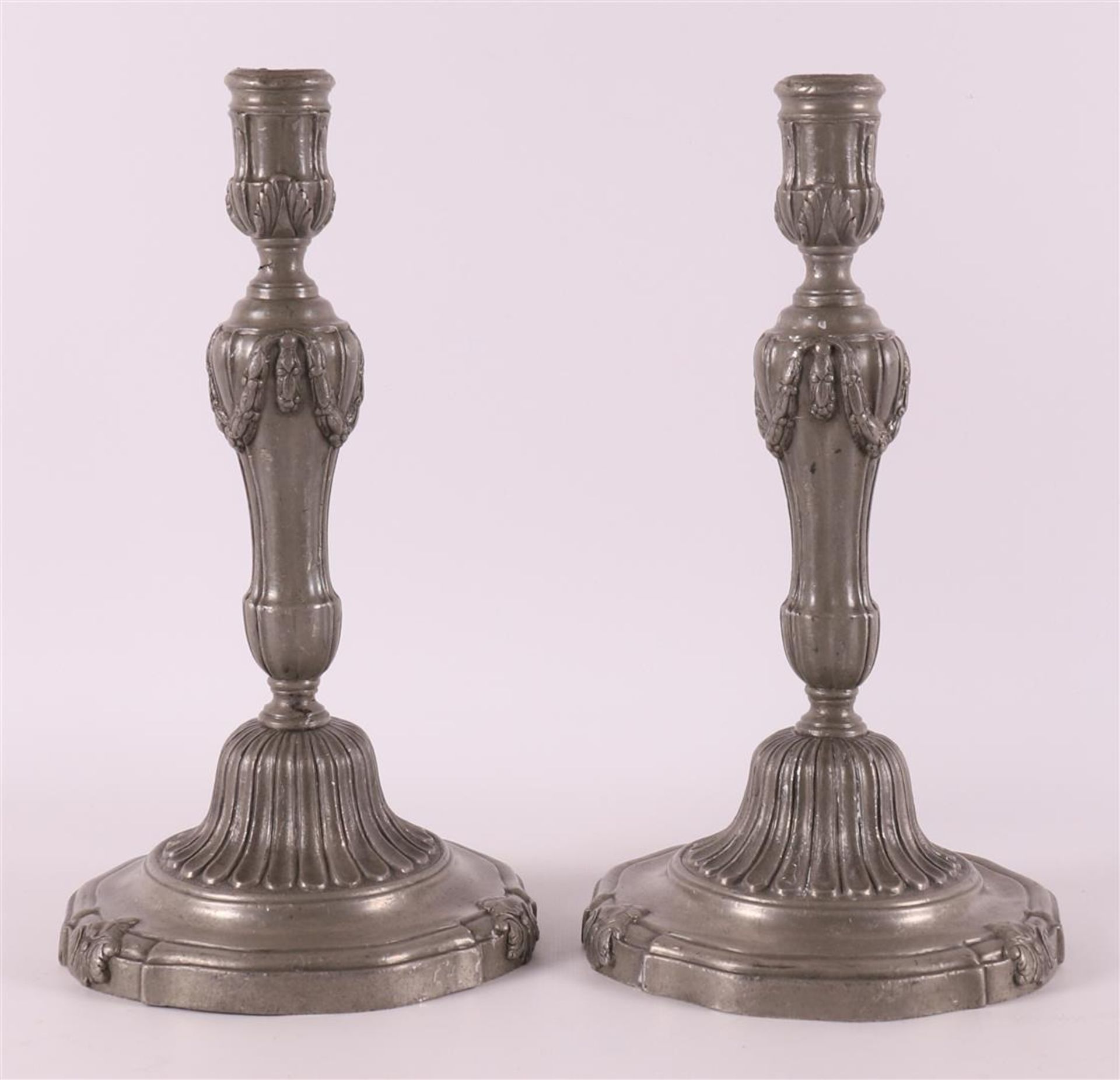 A pair of plain pewter one-light candlesticks, Louis XVI style, 19th century.