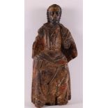 A carved wooden seated apostle with traces of polychromy, 18th century