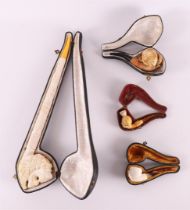 Four various meerschaum pipes in original cases, dating from the 19th century.