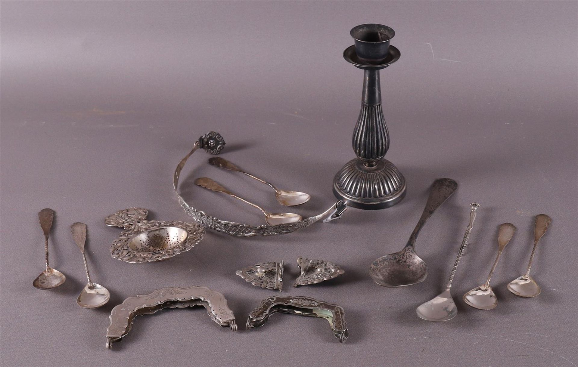 A lot of various silver, including tea strainer and spoons.