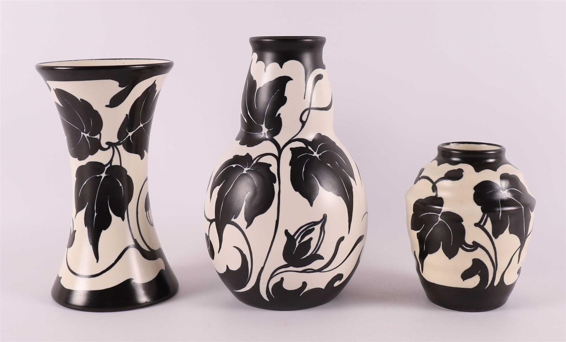 Three black and white earthenware vases, decor 'Fariet', ca. 1930.