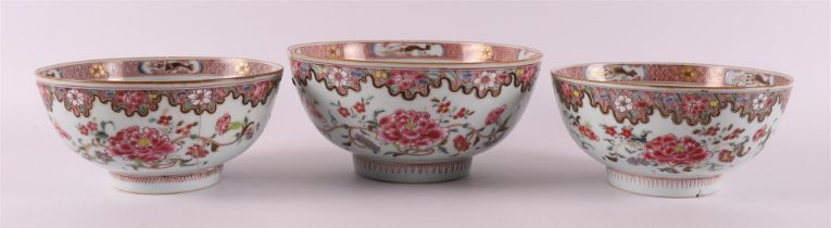 Three famille rose porcelain bowls on stand ring, China, Qianlong, 18th century.