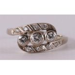 A 14 kt gold vintage ring with one brilliant cut diamond and eight smaller ones.