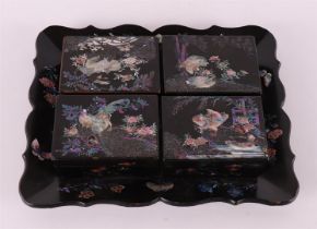 A black lacquer set, Japan, around 1900.