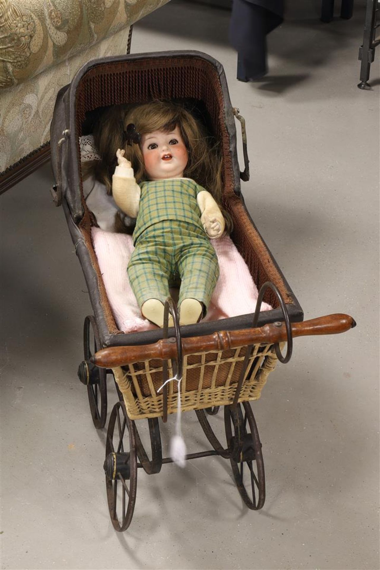 A rattan doll's pram containing a porcelain doll, 19th century - Image 2 of 2