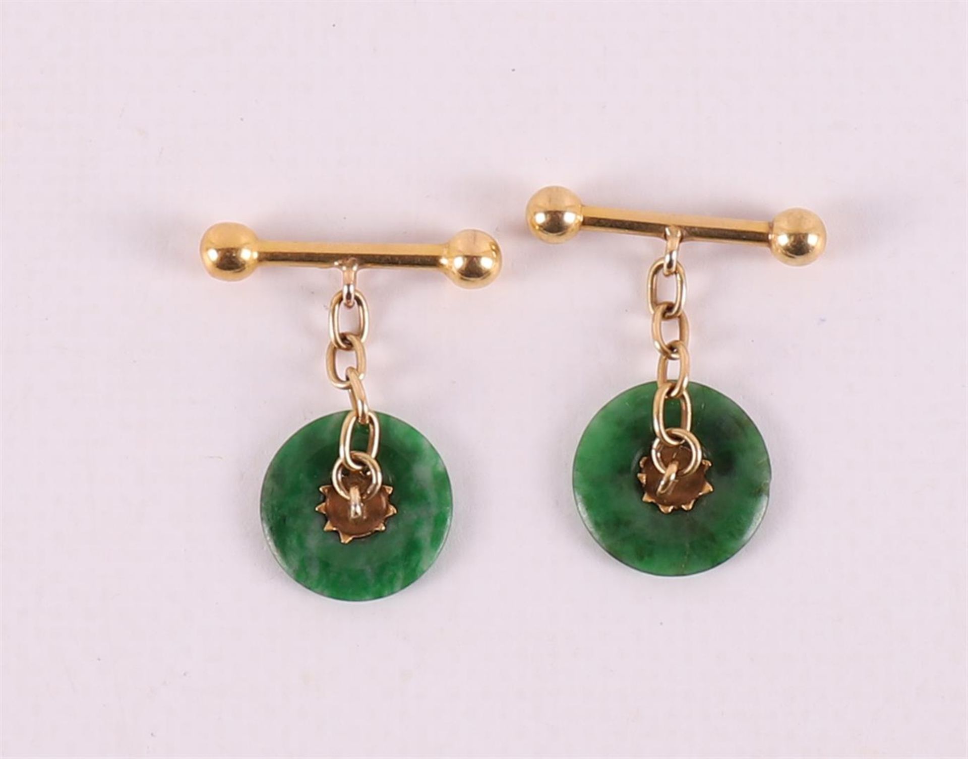 A pair of gold cufflinks with green jade discs. - Image 2 of 3