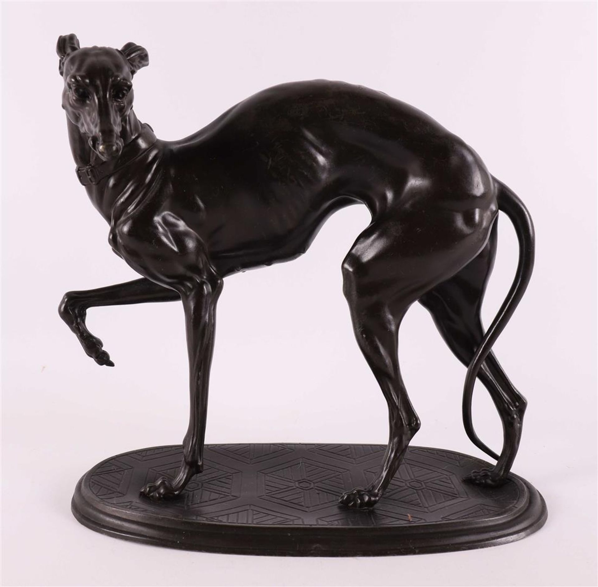 A bronzed white metal sculpture of a greyhound, circa 1900.
