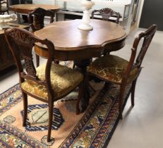 An oval contoured dining room table with four chairs, Holland, 19th century