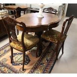 An oval contoured dining room table with four chairs, Holland, 19th century