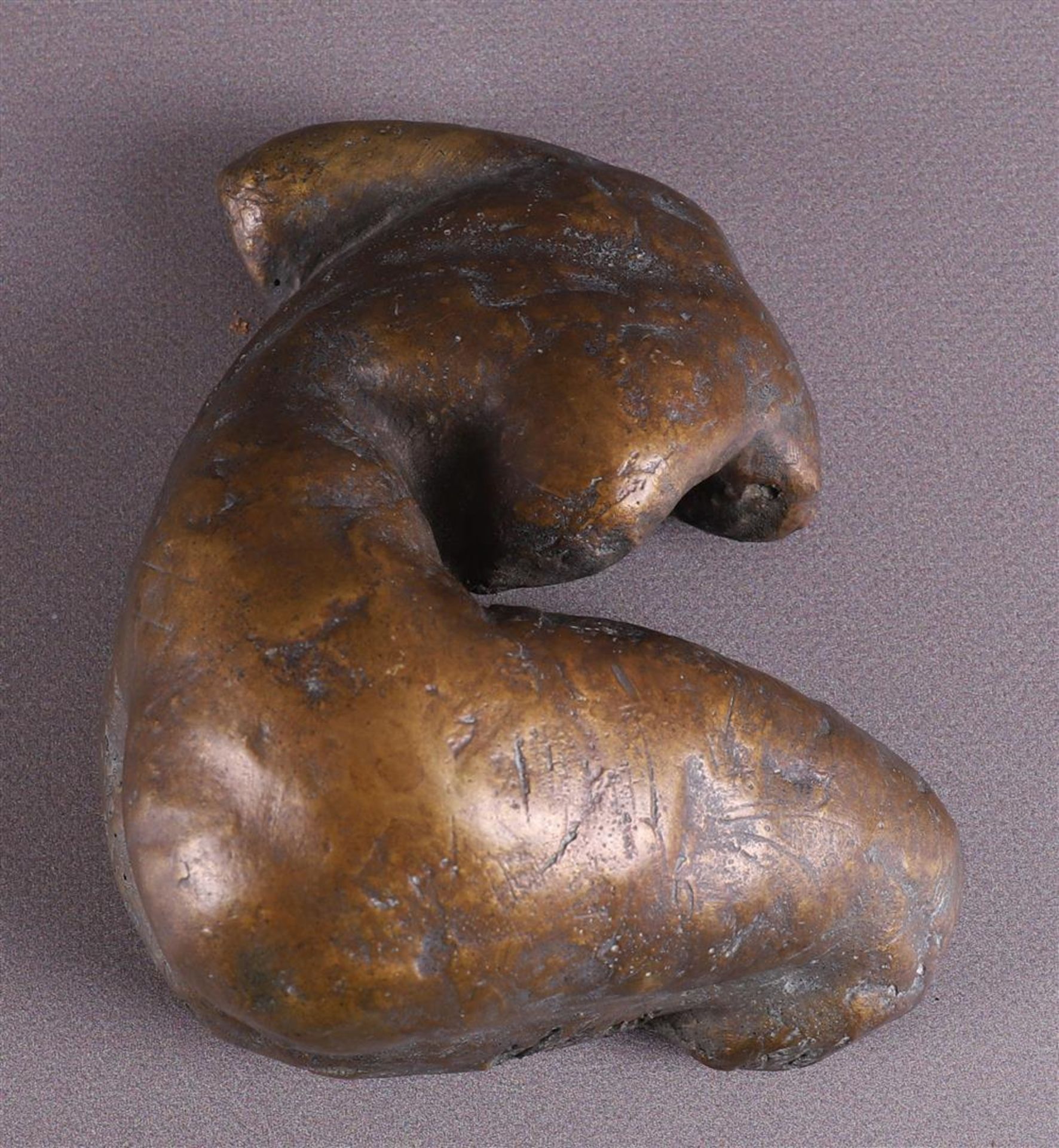 A brown patinated bronze reclining female nude, 20th century.