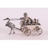 A silver wagon with putto as driver as a deliverer of children, 20th century.