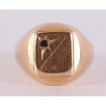 An 18 kt signet ring with colored stone.