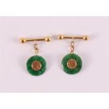 A pair of gold cufflinks with green jade discs.