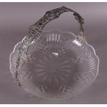 A clear crystal fruit bowl with a silver handle, made from a bible clasp