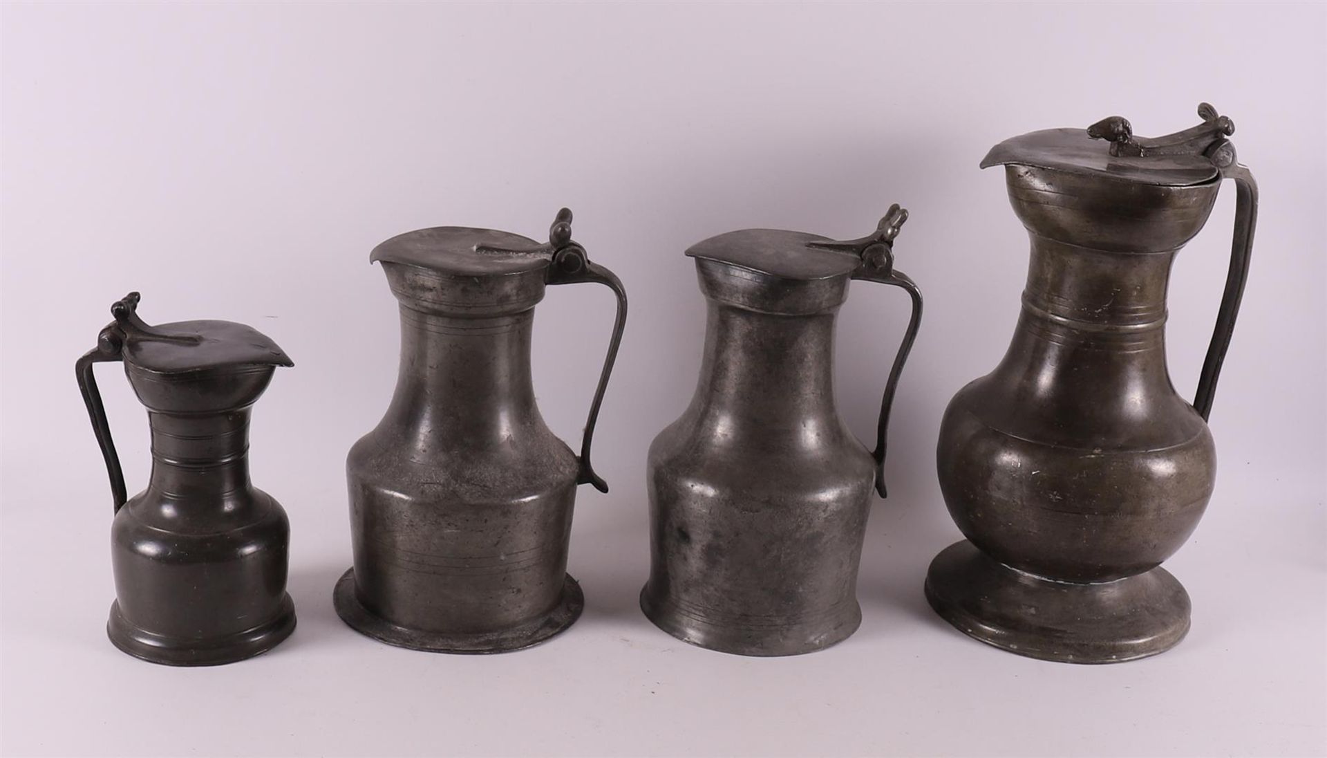 Four various white pewter valve jugs with acorn crown, England 18th century