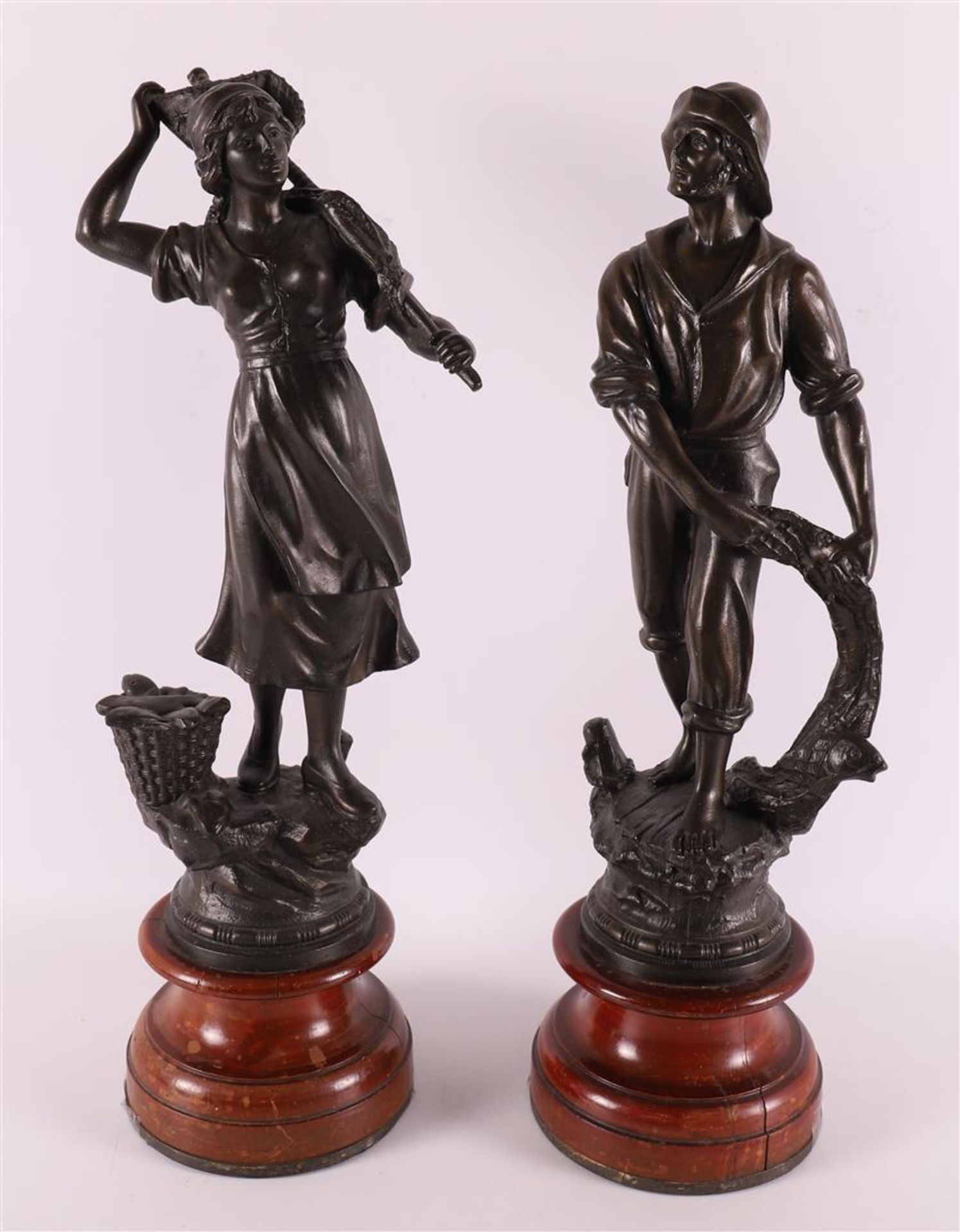 A brown patinated white metal 'samac' fisherman and fisherwoman, France 1900