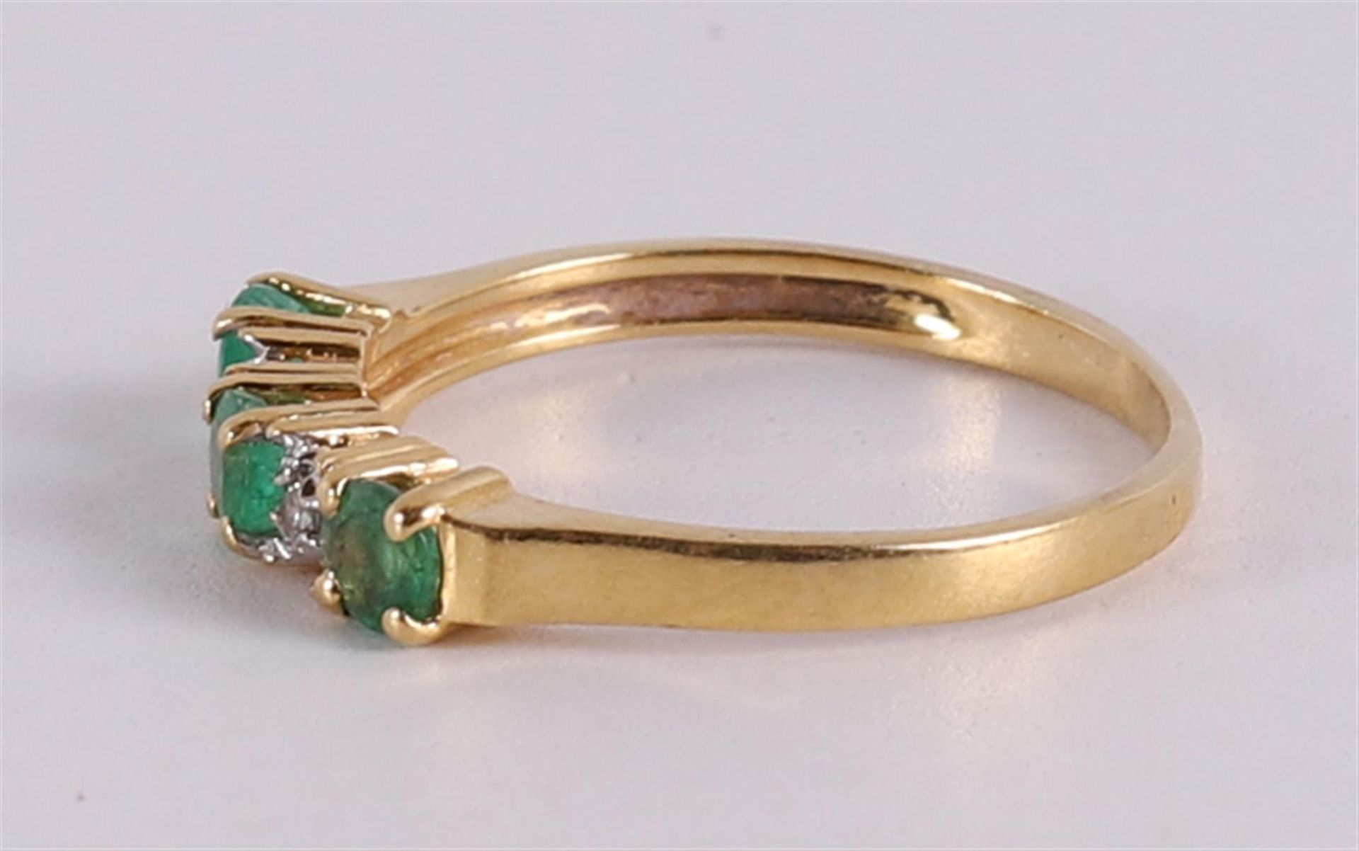 An 18 kt gold row ring with 3 facet cut emeralds and 2 brilliants - Image 2 of 2