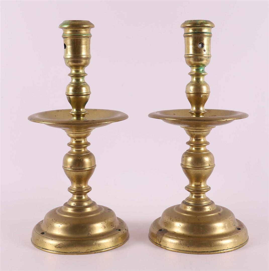 A pair of bronze collar candlesticks, 17th century.