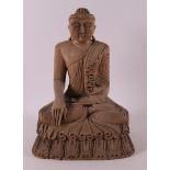 A carved wooden seated Buddha, Nepal/India, 20th century.