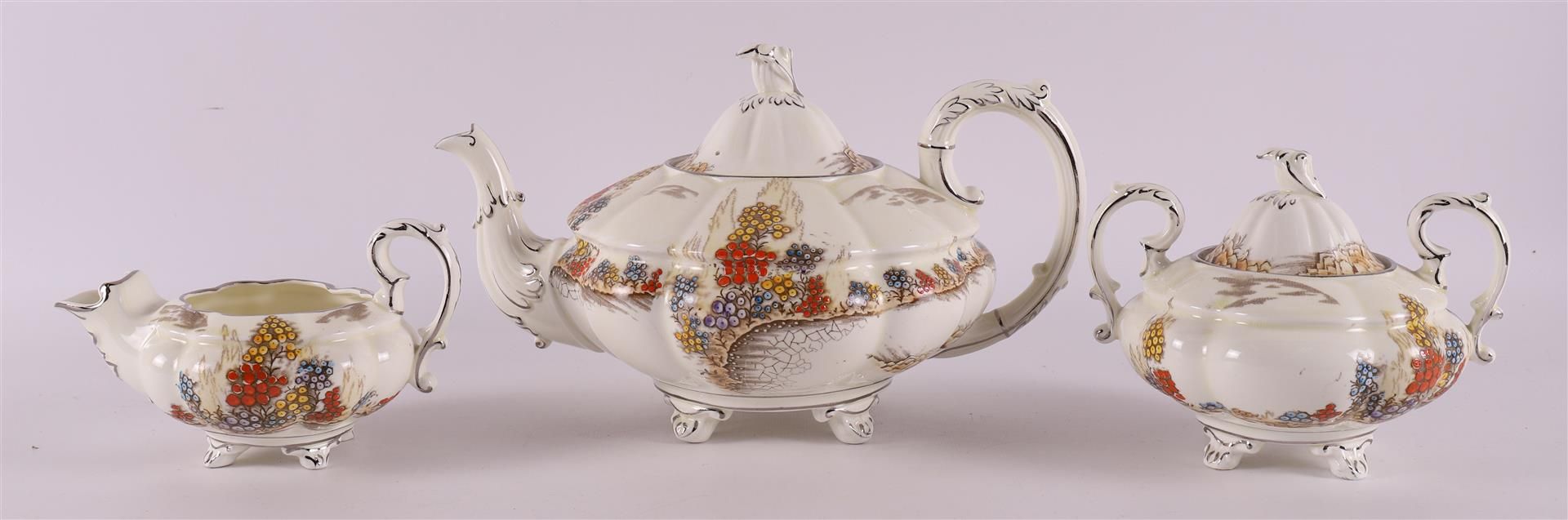 A creamware teapot with sugar bowl and milk jug, England, Stafford, 20th century