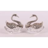 Two white and silver salt shakers in the shape of swans, 20th century.