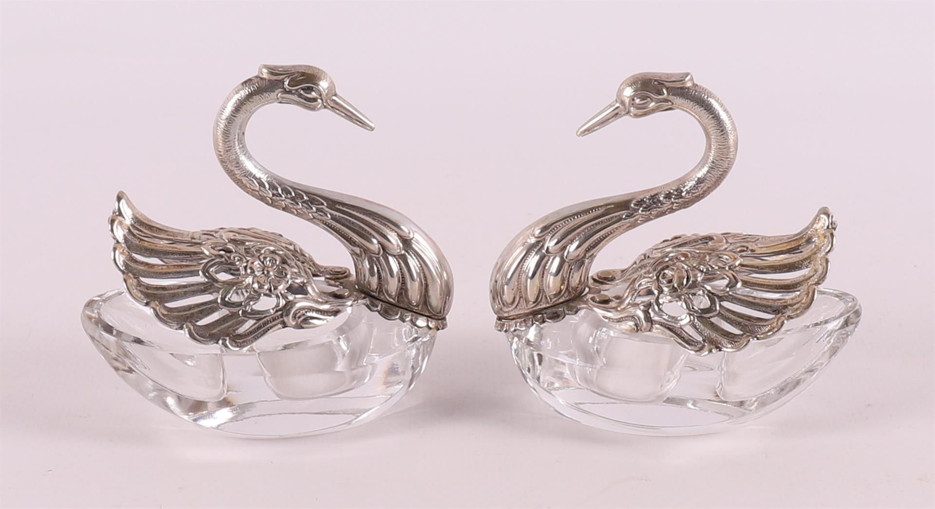 Two white and silver salt shakers in the shape of swans, 20th century.