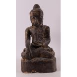 A carved wooden Buddha in lotus position with traces of gilding, Burma,